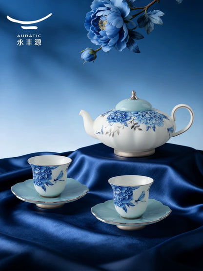 Auratic Platinum Blue & White porcelain teapot with two teacups and sky-blue saucers on blue velvet