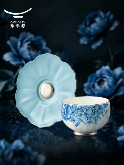 Close-up of a blue peony porcelain teacup on a petal-shaped sky-blue saucer with platinum base