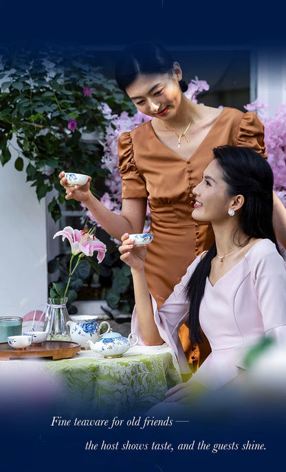 Two women enjoying tea outdoors with an Auratic blue-and-white porcelain tea set